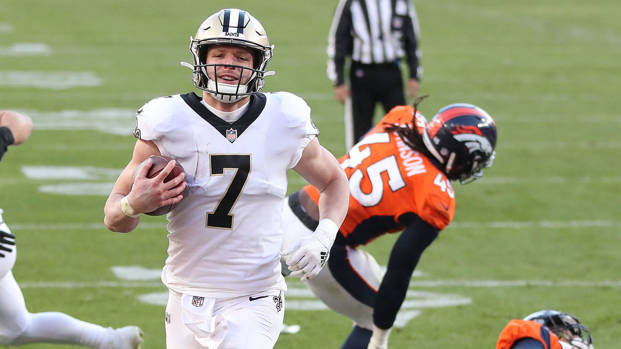 DENVER, COLORADO - NOVEMBER 29: Taysom Hill #7 of the New Orleans Saints rushes for a two yard touchdown during the second quarter of a game against the Denver Broncos at Empower Field At Mile High on November 29, 2020 in Denver, Colorado.