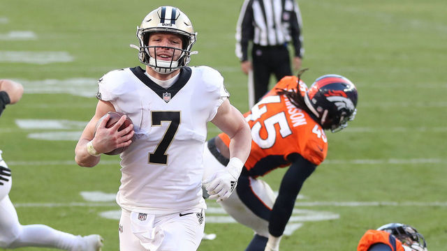 DENVER, COLORADO - NOVEMBER 29: Taysom Hill #7 of the New Orleans Saints rushes for a two yard touchdown during the second quarter of a game against the Denver Broncos at Empower Field At Mile High on November 29, 2020 in Denver, Colorado.