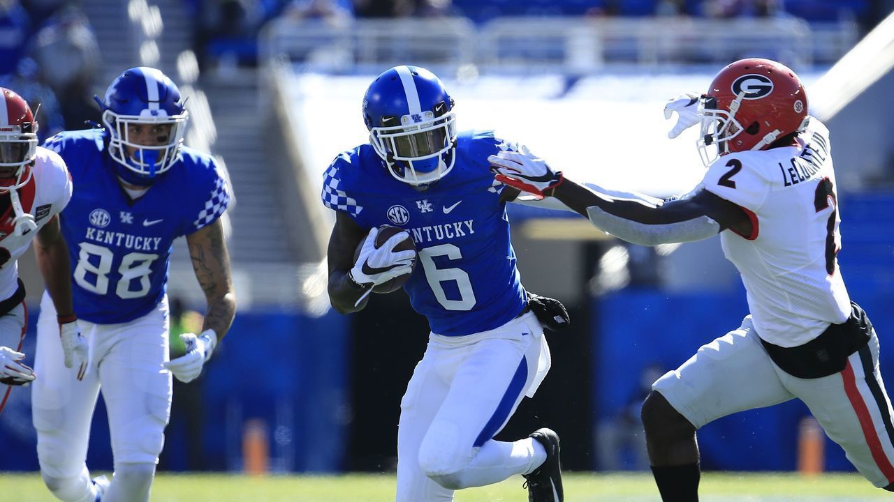 LEXINGTON, KENTUCKY - OCTOBER 31: Josh Ali #6 of the Kentucky Wildcats runs with the ball while defended by Richard LeCounte #2 of the Georgia Bulldogs at Kroger Field on October 31, 2020 in Lexington, Kentucky.