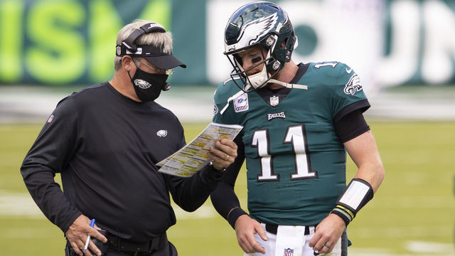 PHILADELPHIA, PA - OCTOBER 18: Head coach Doug Pederson of the Philadelphia Eagles talks to Carson Wentz #11 against the Baltimore Ravens at Lincoln Financial Field on October 18, 2020 in Philadelphia, Pennsylvania.