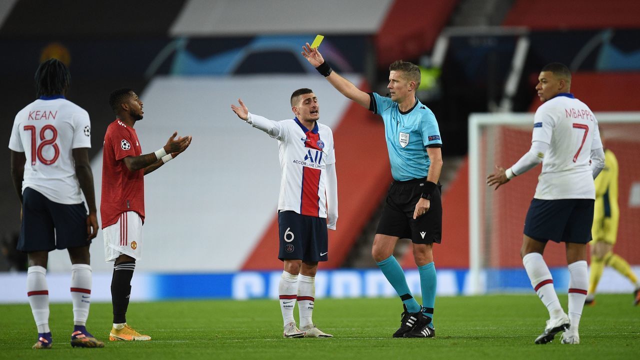 Manchester United's Brazilian midfielder Fred (2L) is shown the yellow card during the UEFA Champions League group H football match between Manchester United and Paris Saint Germain at Old Trafford in Manchester, north west England, on December 2, 2020.