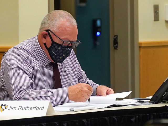 PITTSBURGH, PENNSLYVANIA- OCTOBER 07: General manager Jim Rutherford of the Pittsburgh Penguins sits at the draft table during rounds 2-7 of the 2020 NHL Entry Draft at PPG Paints Arena on October 07, 2020 in Pittsburgh, Pennsylvania. The 2020 NHL Draft was held virtually due to the ongoing Coronavirus pandemic.