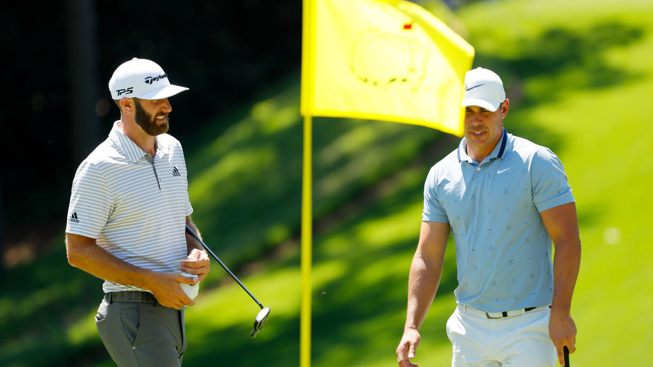 AUGUSTA, GEORGIA - APRIL 10: Dustin Johnson and Brooks Koepka of the United States look on during the Par 3 Contest prior to the Masters at Augusta National Golf Club on April 10, 2019 in Augusta, Georgia.