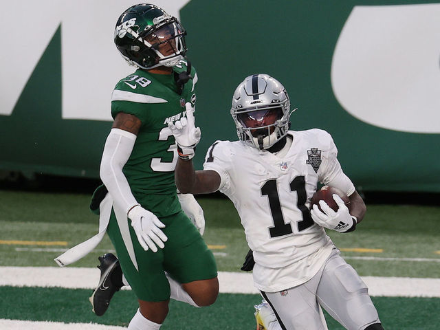 EAST RUTHERFORD, NEW JERSEY - DECEMBER 06: Henry Ruggs III #11 of the Las Vegas Raiders reacts after scoring a touchdown in the final seconds of the second half as Lamar Jackson #38 of the New York Jets looks on at MetLife Stadium on December 06, 2020 in East Rutherford, New Jersey.