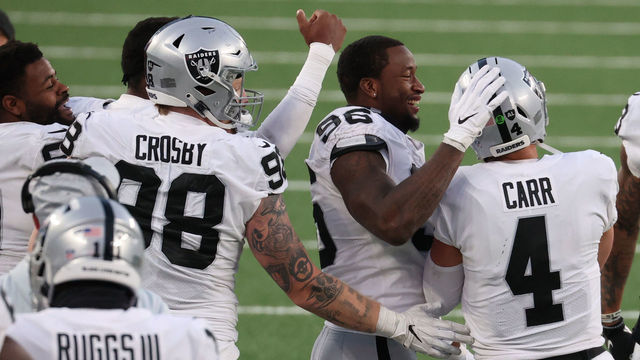 EAST RUTHERFORD, NEW JERSEY - DECEMBER 06: Maxx Crosby #98 and Clelin Ferrell #96 celebrate with Derek Carr #4 of the Las Vegas Raiders after their team's 31-28 win during the second half against the New York Jets at MetLife Stadium on December 06, 2020 in East Rutherford, New Jersey.
