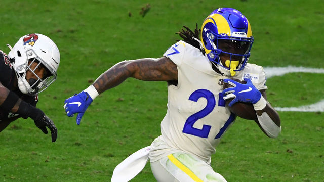 GLENDALE, ARIZONA - DECEMBER 06: Running back Darrell Henderson #27 of the Los Angeles Rams runs the ball for a touchdown as strong safety Budda Baker #32 of the Arizona Cardinals defends during the second half at State Farm Stadium on December 06, 2020 in Glendale, Arizona.