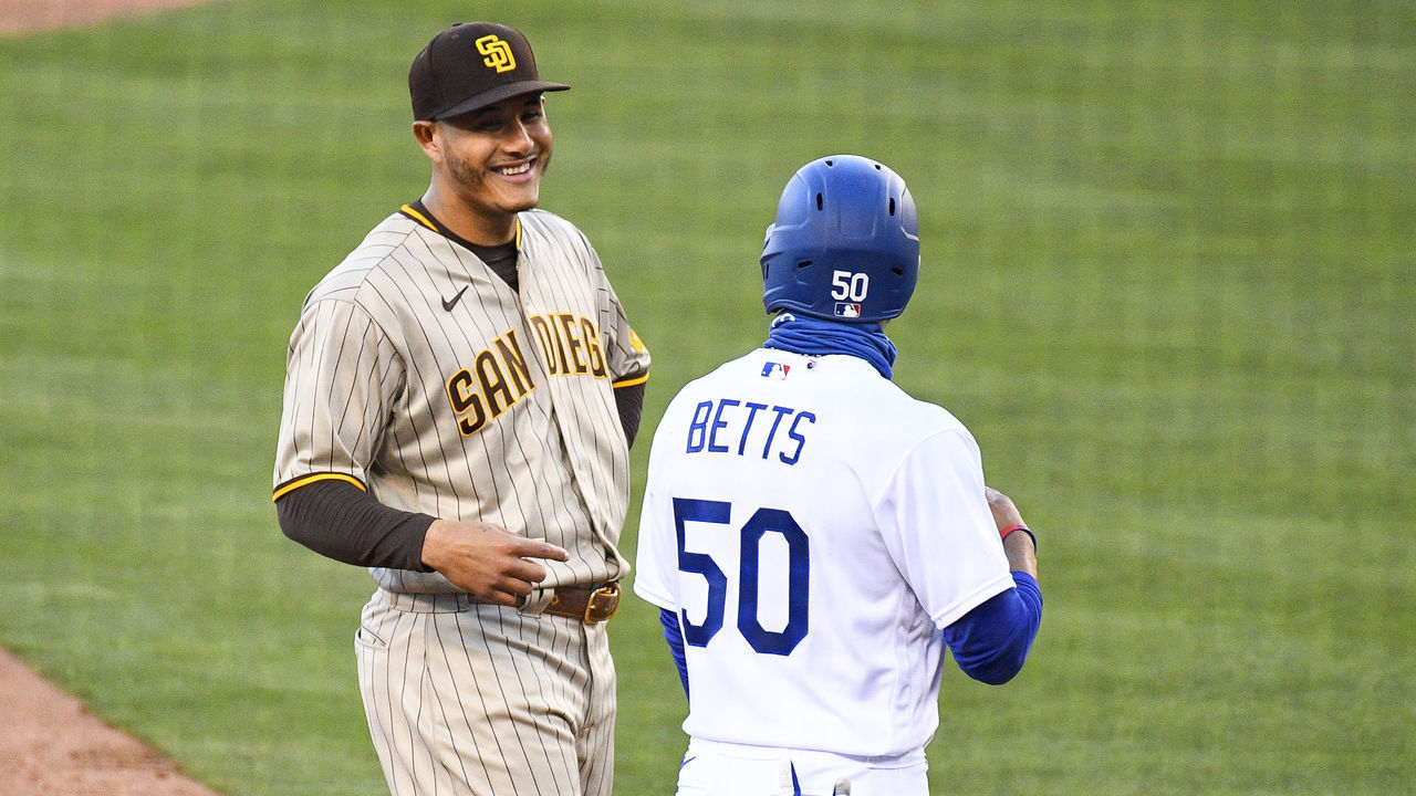 LOS ANGELES, CA - AUGUST 10: San Diego Padres third baseman Manny Machado (13) jokes with Los Angeles Dodgers right fielder Mookie Betts (50) during a MLB game between the San Diego Padres and the Los Angeles Dodgers on August 10, 2020 at Dodger Stadium in Los Angeles, CA. The 2020 regular season has been shortened to 60 games due to the COVID-19 Pandemic.