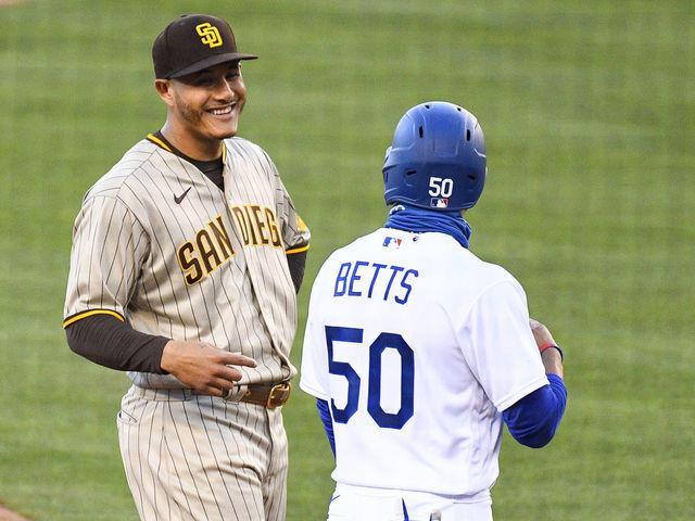 LOS ANGELES, CA - AUGUST 10: San Diego Padres third baseman Manny Machado (13) jokes with Los Angeles Dodgers right fielder Mookie Betts (50) during a MLB game between the San Diego Padres and the Los Angeles Dodgers on August 10, 2020 at Dodger Stadium in Los Angeles, CA. The 2020 regular season has been shortened to 60 games due to the COVID-19 Pandemic.