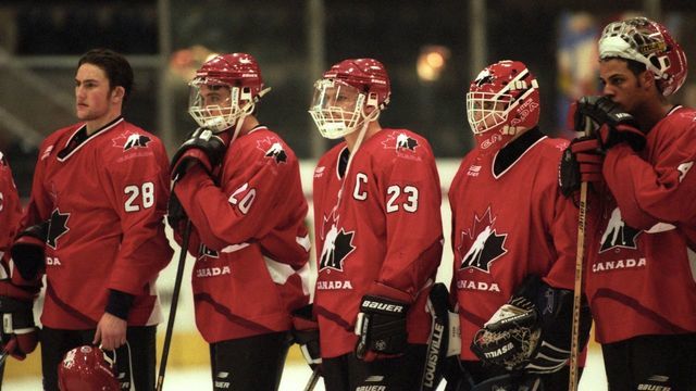 GENEVA - DECEMBER 31: Brad Larsen #23 of Team Canada stands with his teammates after they tied the Czech Republic in the 1997 World Junior Championships game on December 31, 1996 in Geneva, Switzerland.