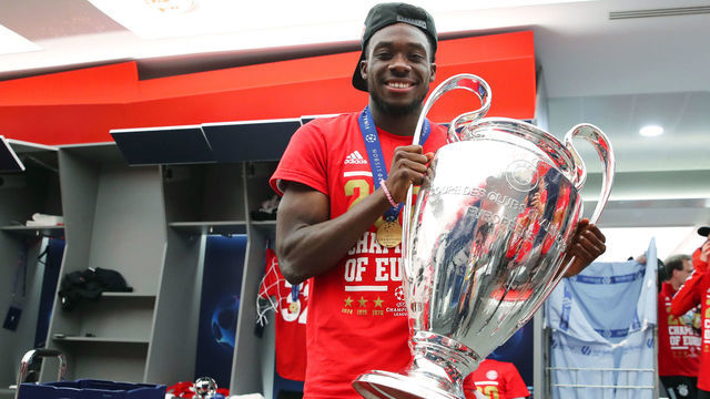 LISBON, PORTUGAL - AUGUST 23: Alphonso Davies of FC Bayern Muenchen poses with the trophy in the dressing room following his team's victory in the UEFA Champions League Final match against Paris Saint-Germain at Estadio do Sport Lisboa e Benfica on August 23, 2020 in Lisbon, Portugal.
