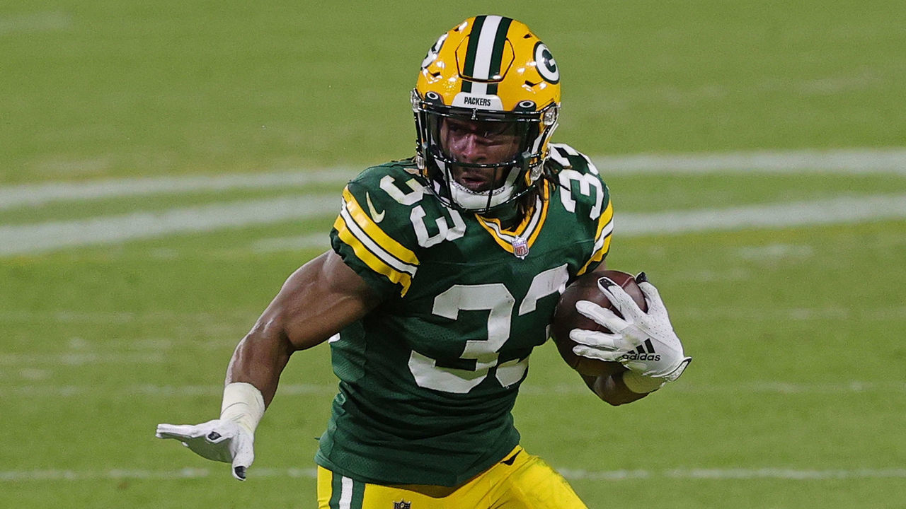 GREEN BAY, WISCONSIN - DECEMBER 06: Aaron Jones #33 of the Green Bay Packers runs for yards during a game against the Philadelphia Eagles at Lambeau Field on December 06, 2020 in Green Bay, Wisconsin. The Packers defeated the Eagles 30-16.