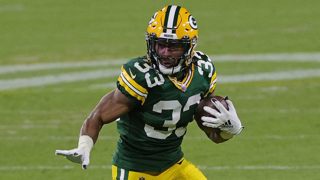 GREEN BAY, WISCONSIN - DECEMBER 06: Aaron Jones #33 of the Green Bay Packers runs for yards during a game against the Philadelphia Eagles at Lambeau Field on December 06, 2020 in Green Bay, Wisconsin. The Packers defeated the Eagles 30-16.