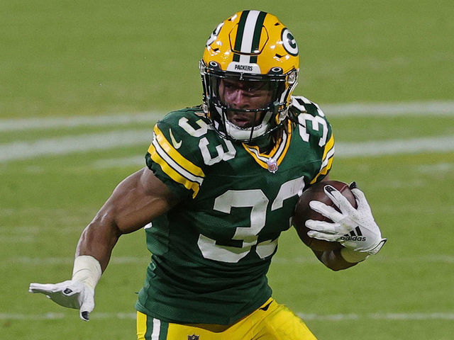 GREEN BAY, WISCONSIN - DECEMBER 06: Aaron Jones #33 of the Green Bay Packers runs for yards during a game against the Philadelphia Eagles at Lambeau Field on December 06, 2020 in Green Bay, Wisconsin. The Packers defeated the Eagles 30-16.