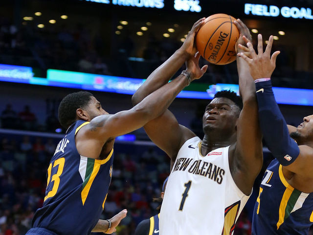 NEW ORLEANS, LOUISIANA - OCTOBER 11: Zion Williamson #1 of the New Orleans Pelicans is fouled by Royce O'Neale #23 of the Utah Jazz and Donovan Mitchell #45 during a game at the Smoothie King Center on October 11, 2019 in New Orleans, Louisiana.