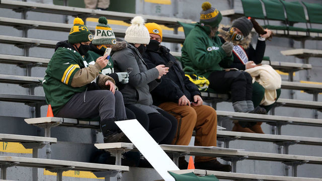 GREEN BAY, WISCONSIN - DECEMBER 06: Fans watch warm-ups prior to the game between the Green Bay Packers and the Philadelphia Eagles at Lambeau Field on December 06, 2020 in Green Bay, Wisconsin.