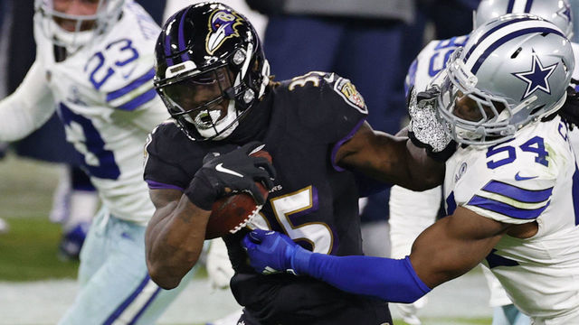 BALTIMORE, MARYLAND - DECEMBER 08: Running back Gus Edwards #35 of the Baltimore Ravens rushes past middle linebacker Jaylon Smith #54 of the Dallas Cowboys during the fourth quarter at M&T Bank Stadium on December 8, 2020 in Baltimore, Maryland.