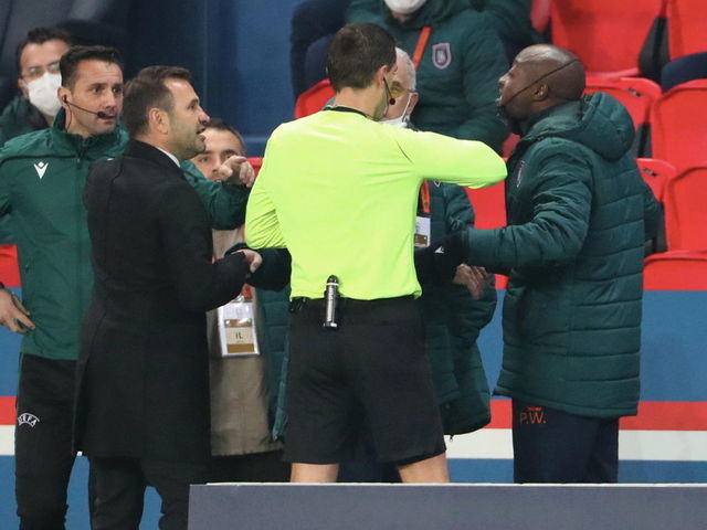 PARIS, FRANCE - DECEMBER 08: Pierre-Achille Webo of Istanbul talks with referee Ovidiu Alin Hategan during the confusion following an alleged incident between Istanbul Basaksehir assistant manager Pierre Achille Webo and the 4th official Sebastian Coltescu during the UEFA Champions League Group H stage match between Paris Saint-Germain and Istanbul Basaksehir at Parc des Princes on December 8, 2020 in Paris, France.