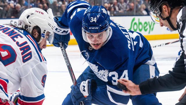 TORONTO, ON - DECEMBER 28: Auston Matthews #34 of the Toronto Maple Leafs takes a face off against Mika Zibanejad #93 of the New York Rangers during the second period at the Scotiabank Arena on December 28, 2019 in Toronto, Ontario, Canada.