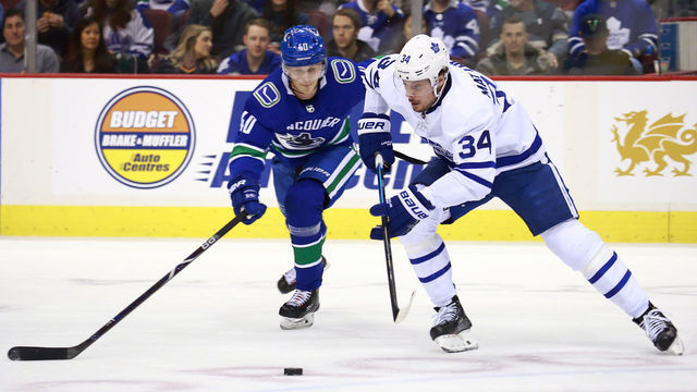 VANCOUVER, BC - MARCH 6: Elias Pettersson #40 of the Vancouver Canucks and Auston Matthews #34 of the Toronto Maple Leafs race to the puck during their NHL game Rogers Arena March 6, 2019 in Vancouver, British Columbia, Canada. "n