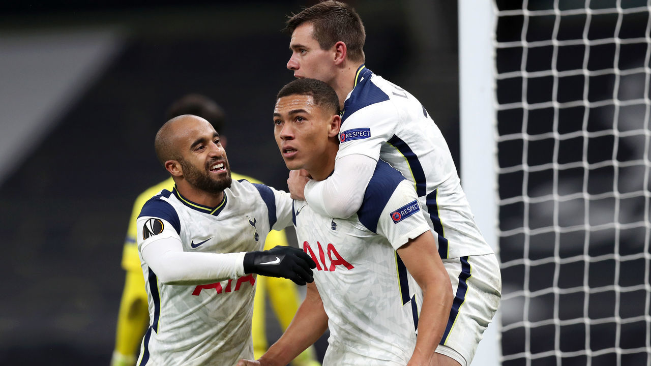 LONDON, ENGLAND - DECEMBER 10: Carlos Vinicius of Tottenham Hotspur celebrates with Giovani Lo Celso and Lucas Moura after scoring his sides 1st goal after scoring their team's first goal during the UEFA Europa League Group J stage match between Tottenham Hotspur and Royal Antwerp at Tottenham Hotspur Stadium on December 10, 2020 in London, England. A limited number of fans (2000) are welcomed back to stadiums to watch elite football across England. This was following easing of restrictions on spectators in tiers one and two areas only.