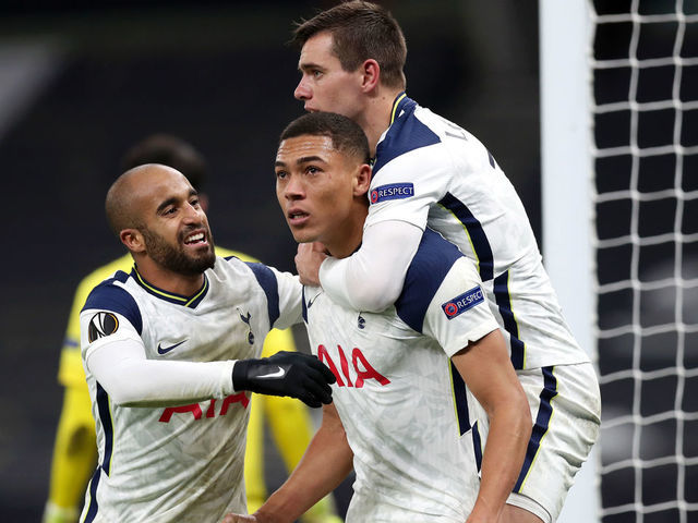 LONDON, ENGLAND - DECEMBER 10: Carlos Vinicius of Tottenham Hotspur celebrates with Giovani Lo Celso and Lucas Moura after scoring his sides 1st goal after scoring their team's first goal during the UEFA Europa League Group J stage match between Tottenham Hotspur and Royal Antwerp at Tottenham Hotspur Stadium on December 10, 2020 in London, England. A limited number of fans (2000) are welcomed back to stadiums to watch elite football across England. This was following easing of restrictions on spectators in tiers one and two areas only.
