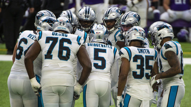 MINNEAPOLIS, MN - NOVEMBER 29: Carolina Panthers players huddle up in the first quarter of the game against the Minnesota Vikings at U.S. Bank Stadium on November 29, 2020 in Minneapolis, Minnesota.