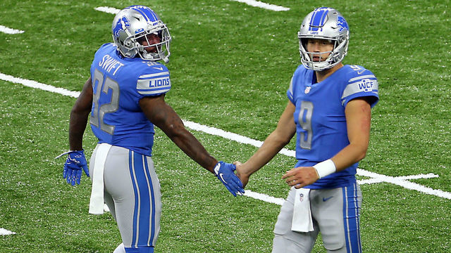Detroit Lions running back D'Andre Swift (32) is congratulated by Detroit Lions quarterback Matthew Stafford (9) after making yardage during the first half of an NFL football game against the New Orleans Saints in Detroit, Michigan USA, on Sunday, October 4, 2020.