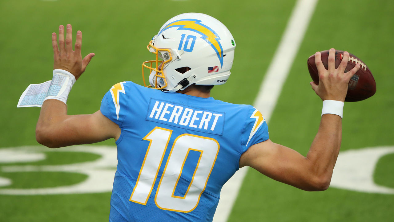 INGLEWOOD, CALIFORNIA - DECEMBER 06: Quarterback Justin Herbert #10 of the Los Angeles Chargers motions to pass the ball in the first half of the game against the New England Patriots at SoFi Stadium on December 06, 2020 in Inglewood, California.