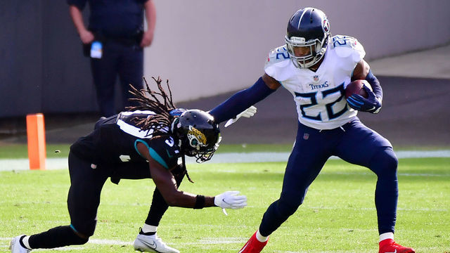 JACKSONVILLE, FLORIDA - DECEMBER 13: Derrick Henry #22 of the Tennessee Titans stiff arms Tre Herndon #37 of the Jacksonville Jaguars at TIAA Bank Field on December 13, 2020 in Jacksonville, Florida.