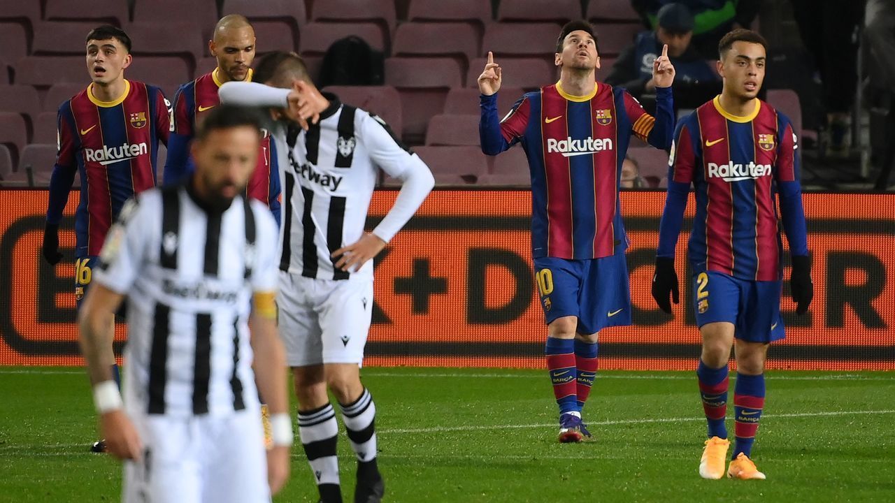 Barcelona's Argentinian forward Lionel Messi (2R) celebrates after scoring during the Spanish league football match between FC Barcelona and Levante UD at the Camp Nou stadium in Barcelona on December 13, 2020.