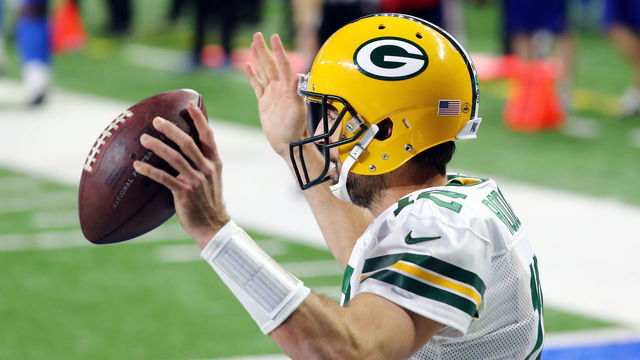 DETROIT, MICHIGAN - DECEMBER 13: Aaron Rodgers #12 of the Green Bay Packers celebrates rushing for a touchdown during the third quarter against the Detroit Lions at Ford Field on December 13, 2020 in Detroit, Michigan.