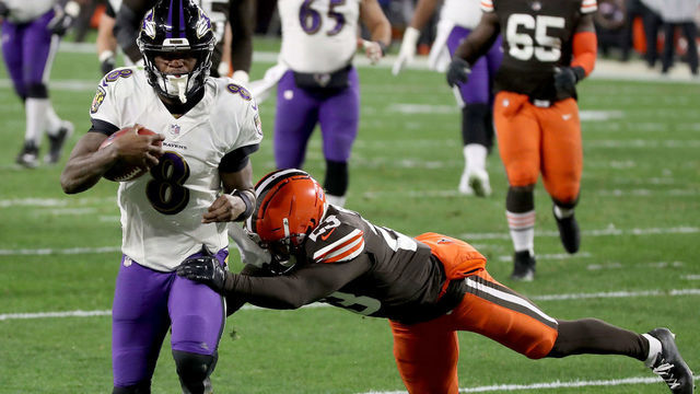 CLEVELAND, OHIO - DECEMBER 14: Lamar Jackson #8 of the Baltimore Ravens scores a touchdown during the second quarter in the game against the Cleveland Browns at FirstEnergy Stadium on December 14, 2020 in Cleveland, Ohio.