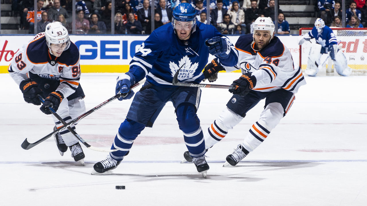 TORONTO, ON - JANUARY 06: Tyson Barrie #94 of the Toronto Maple Leafs battles for the puck against Zack Kassian #44 of the Edmonton Oilers and Ryan Nugent-Hopkins #93 during the third period at the Scotiabank Arena on January 6, 2020 in Toronto, Ontario, Canada.