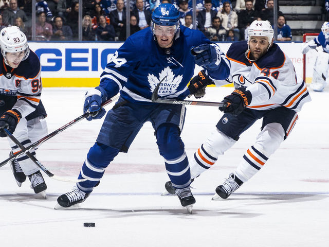 TORONTO, ON - JANUARY 06: Tyson Barrie #94 of the Toronto Maple Leafs battles for the puck against Zack Kassian #44 of the Edmonton Oilers and Ryan Nugent-Hopkins #93 during the third period at the Scotiabank Arena on January 6, 2020 in Toronto, Ontario, Canada.