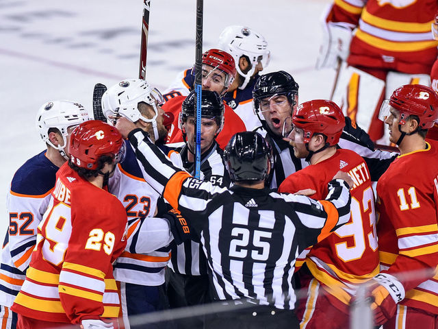 CALGARY, AB - FEBRUARY 01: Officials try to get between Edmonton Oilers Center Riley Sheahan (23) and Calgary Flames Winger Sam Bennett (93) during the third period of an NHL game where the Calgary Flames hosted the Edmonton Oilers on February 1, 2020, at the Scotiabank Saddledome in Calgary, AB.