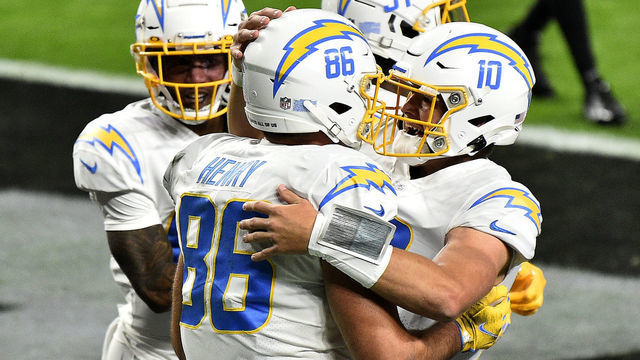 LAS VEGAS, NEVADA - DECEMBER 17: Hunter Henry #86 of the Los Angeles Chargers celebrates with Justin Herbert #10 after scoring a 10 yard touchdown against the Las Vegas Raiders during the first half of the game at Allegiant Stadium on December 17, 2020 in Las Vegas, Nevada.