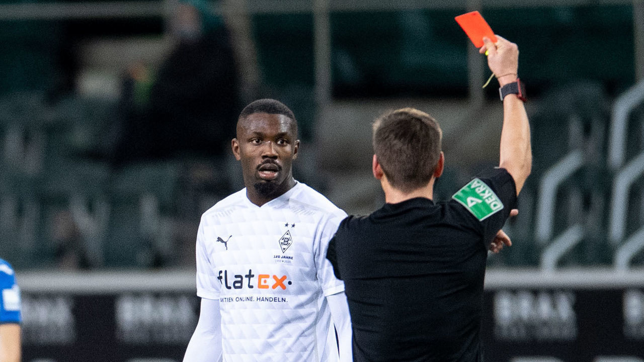 Referee Frank Willenborg shows Moenchengladbach's French forward Marcus Thuram the red card during the German first division Bundesliga football match Borussia Moenchengladbach v TSG 1899 Hoffenheim in Moenchengladbach, on December 19, 2020.
