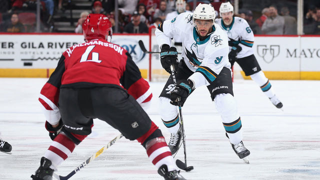 GLENDALE, ARIZONA - JANUARY 14: Evander Kane #9 of the San Jose Sharks skates with the puck against Niklas Hjalmarsson #4 of the Arizona Coyotes during the third period of the NHL game at Gila River Arena on January 14, 2020 in Glendale, Arizona. The Coyotes defeated the Sharks 6-3.