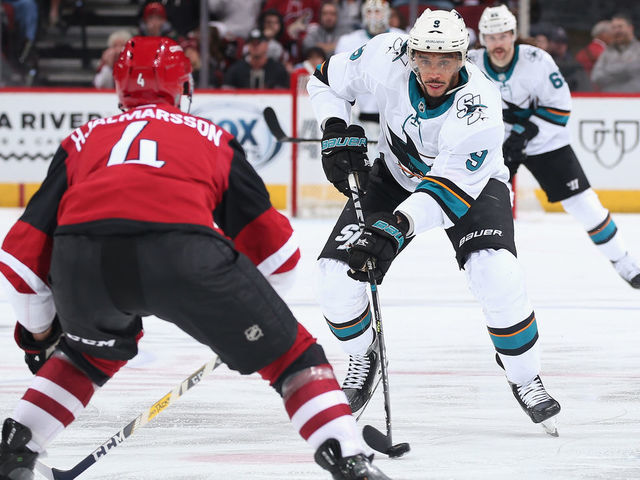 GLENDALE, ARIZONA - JANUARY 14: Evander Kane #9 of the San Jose Sharks skates with the puck against Niklas Hjalmarsson #4 of the Arizona Coyotes during the third period of the NHL game at Gila River Arena on January 14, 2020 in Glendale, Arizona. The Coyotes defeated the Sharks 6-3.