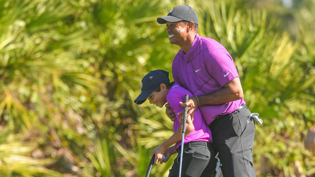 ORLANDO, FL - DECEMBER 19: Tiger Woods hugs his son Charlie Woods after making an eagle on the third green during the first round of the PGA TOUR Champions PNC Championship at Ritz-Carlton Golf Club on December 19, 2020 in Orlando, Florida.