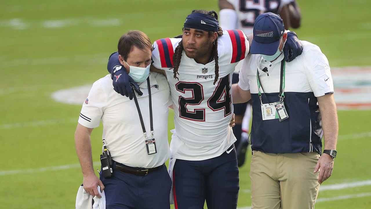 MIAMI GARDENS, FL - DECEMBER 20: New England Patriots staff help an injured Stephon Gilmore of the field. The Miami Dolphins host the New England Patriots in an NFL game at Hard Rock Stadium in Miami Gardens, FL on Dec. 13, 2020.