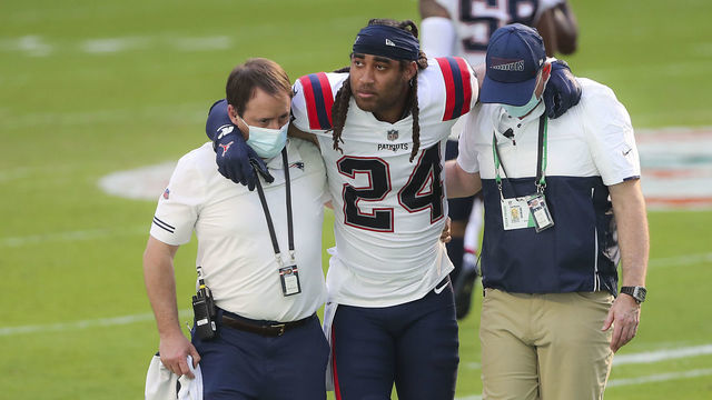 MIAMI GARDENS, FL - DECEMBER 20: New England Patriots staff help an injured Stephon Gilmore of the field. The Miami Dolphins host the New England Patriots in an NFL game at Hard Rock Stadium in Miami Gardens, FL on Dec. 13, 2020.