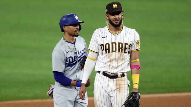 ARLINGTON, TEXAS - OCTOBER 08: Mookie Betts #50 of the Los Angeles Dodgers reacts with Fernando Tatis Jr. #23 of the San Diego Padres at second base during the third inning in Game Three of the National League Division Series at Globe Life Field on October 08, 2020 in Arlington, Texas.