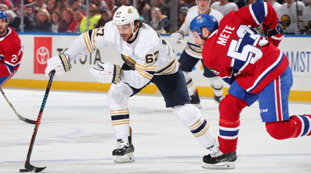BUFFALO, NY - JANUARY 30: Michael Frolik #67 of the Buffalo Sabres skates with the puck against Victor Mete #53 of the Montreal Canadiens during an NHL game on January 30, 2020 at KeyBank Center in Buffalo, New York.