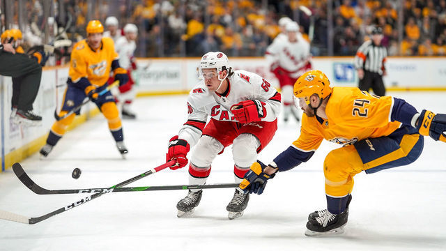 NASHVILLE, TN - FEBRUARY 18: Erik Haula #56 of the Carolina Hurricanes battles for the puck against Jarred Tinordi #24 of the Nashville Predators at Bridgestone Arena on February 18, 2020 in Nashville, Tennessee.