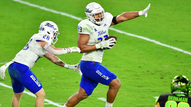 TAMPA, FLORIDA - OCTOBER 23: Zaven Collins #23 of the Tulsa Golden Hurricane celebrates after intercepting Noah Johnson #0 of the South Florida Bulls and running in a 38-yard touchdown during the third quarter at Raymond James Stadium on October 23, 2020 in Tampa, Florida.