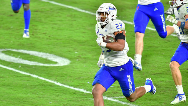 TAMPA, FLORIDA - OCTOBER 23: Zaven Collins #23 of the Tulsa Golden Hurricane runs in a touchdown after intercepting a pass thrown by Noah Johnson #0 of the South Florida Bulls during the second half at Raymond James Stadium on October 23, 2020 in Tampa, Florida.
