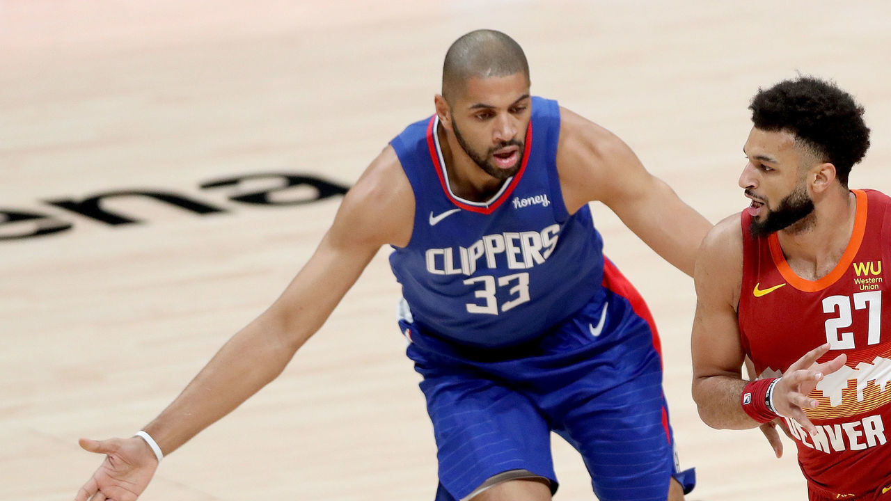 DENVER, COLORADO - DECEMBER 25: Jamal Murray #27 of the Denver Nuggets drives against Nicolas Batum #33 of the Los Angeles Clippers in the first quarter at Ball Arena on December 25, 2020 in Denver, Colorado.
