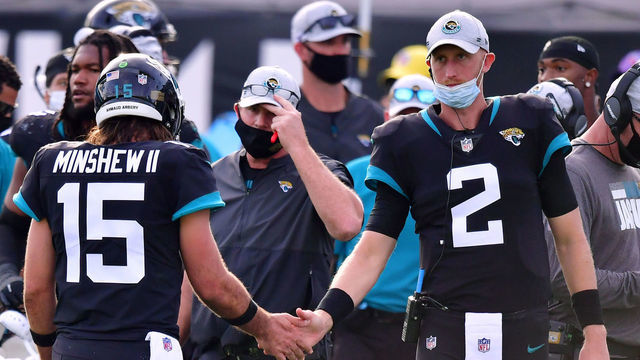 JACKSONVILLE, FLORIDA - DECEMBER 13: Gardner Minshew #15 of the Jacksonville Jaguars and Mike Glennon #2 shake hands on the sideline during the game against the Tennessee Titans at TIAA Bank Field on December 13, 2020 in Jacksonville, Florida.