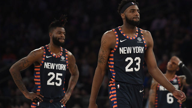 NEW YORK, NEW YORK - JANUARY 12: Mitchell Robinson #23 and Reggie Bullock #25 of the New York Knicks look on during the first half of the game against the Miami Heat at Madison Square Garden on January 12, 2020 in New York City.